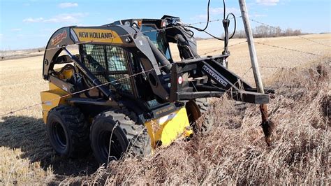 putting in post in a vineyard with a skid steer|skid steer fence posts.